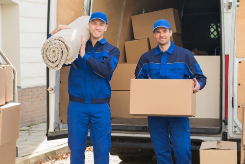 Removal team carrying furniture from a flat in Shoreditch