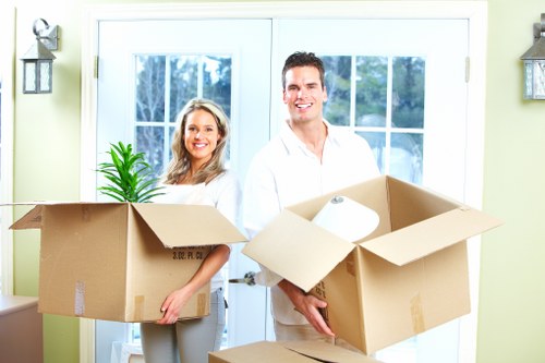 Professional movers carrying furniture through a Shoreditch property